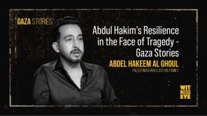 Portrait of Abdul Hakim Al-Ghoul working at his desk, reflecting determination and resilience after losing his family in Gaza.