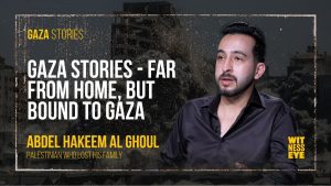 Palestinian journalist Abdul Hakim Al-Ghoul sitting in exile, holding a photo of his family lost in Gaza bombings.